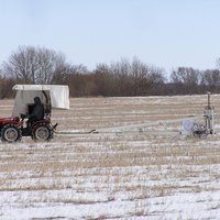 Geomagnetical measuring in progress with tractor and equipment of the geophysicans